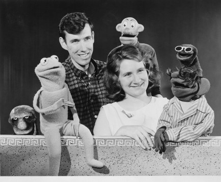Jim and Jane Henson pose with several puppets.