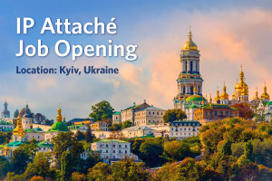 Text says “IP Attache Job Opening, Location: Kyiv, Ukraine”. Scenic cityscape photo of the Kiev Monastery of the Caves in Kyiv, Ukraine. 